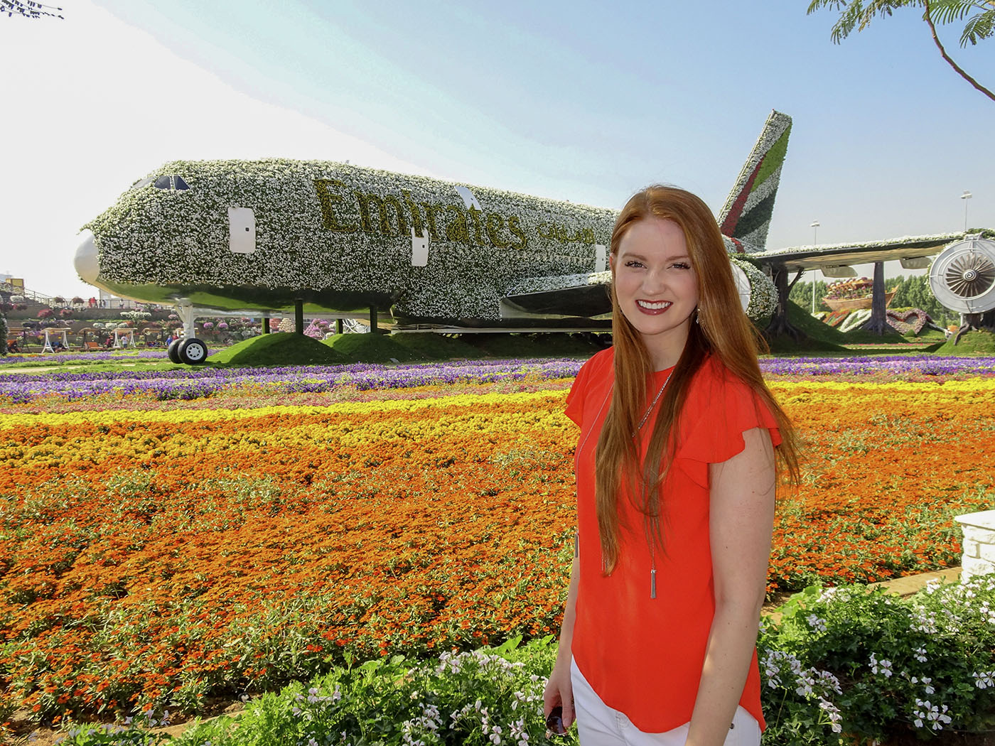 Callie beside a vivid floral aircraft display