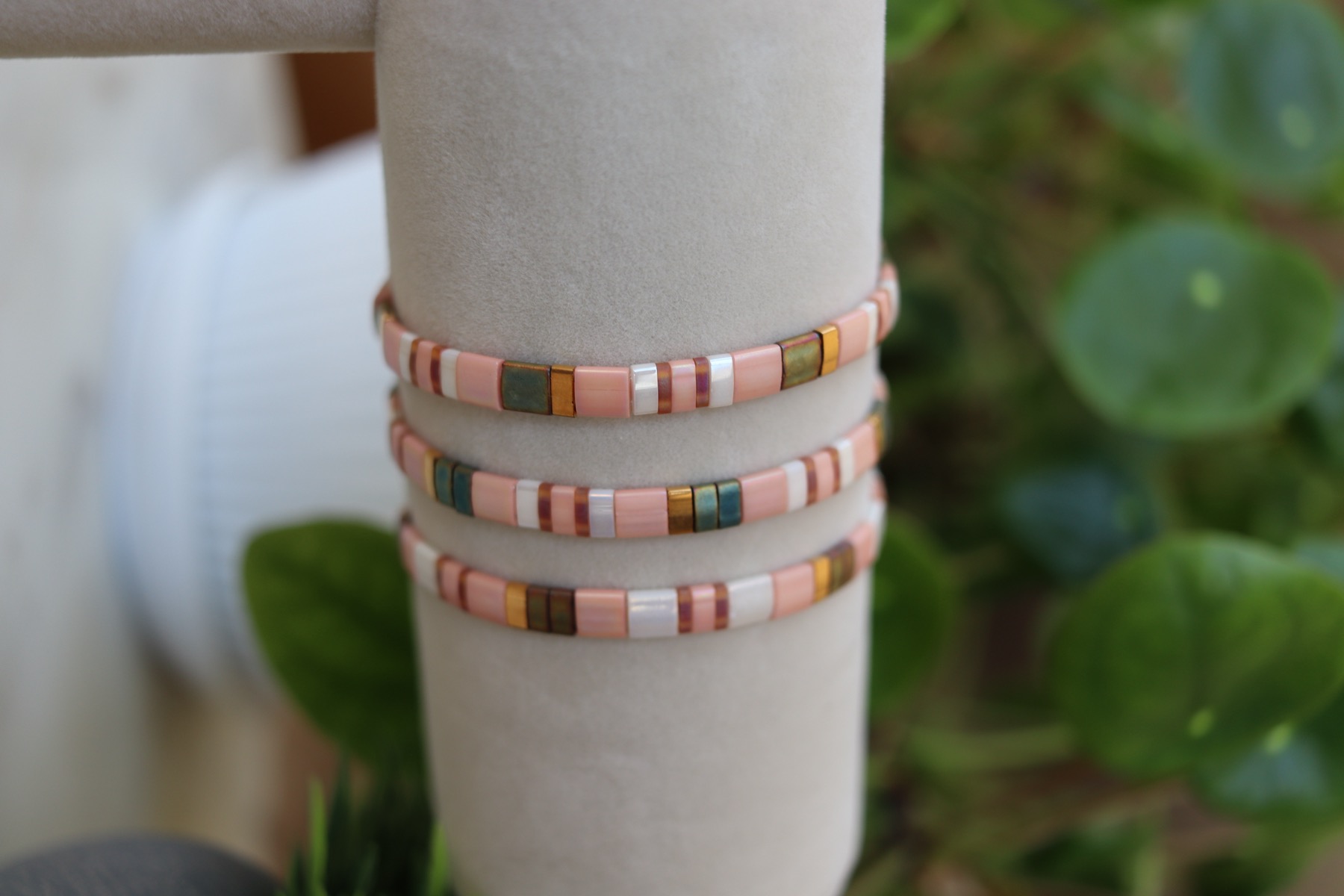 Owner-supplied photograph of a blush-toned bracelet stack on a wrist