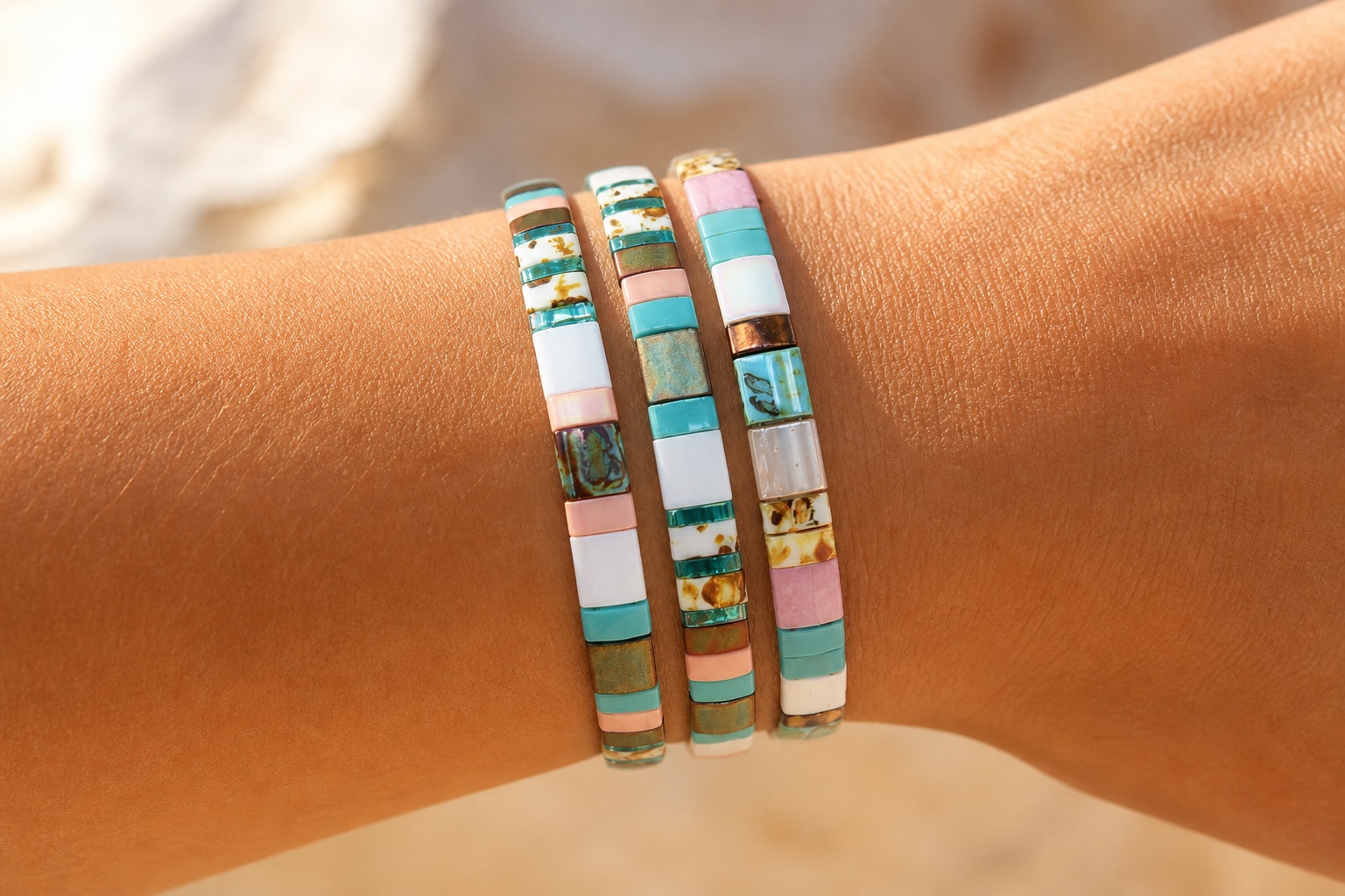 Editorial concept of a close wrist wearing three snug colorful tile bracelets