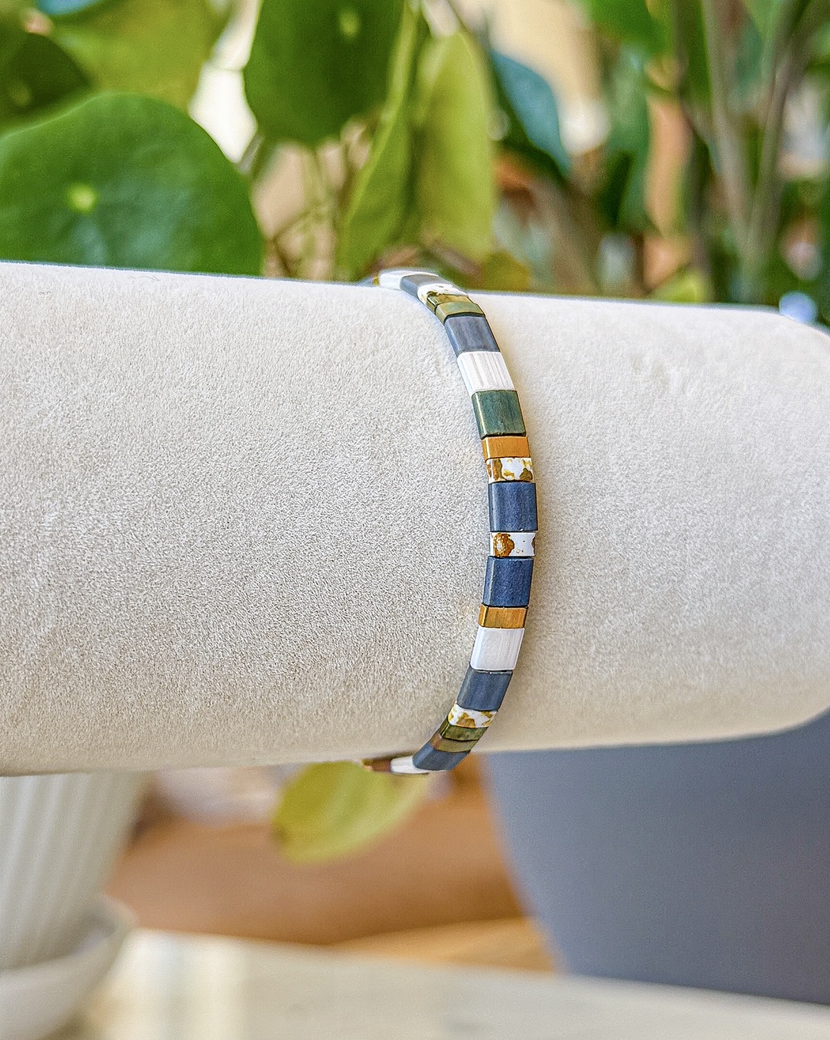 Bracelet close-up photograph in slate, ivory, and gold tones