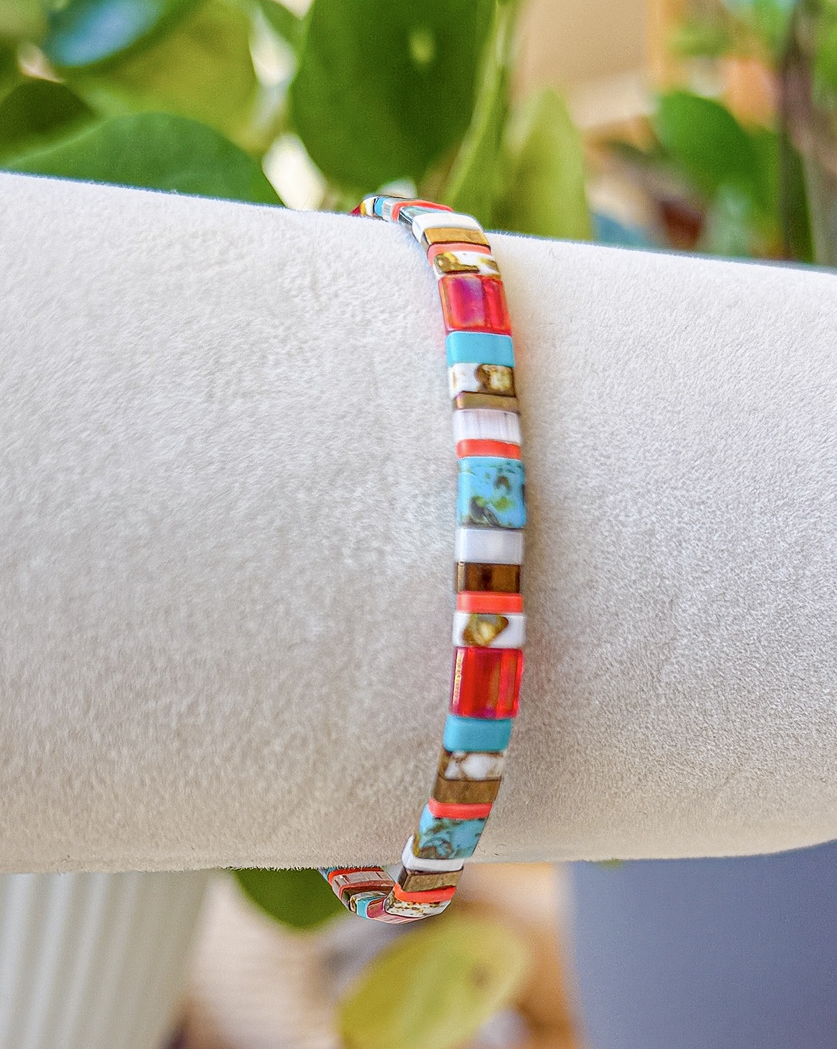 Bracelet close-up photograph in turquoise, coral, and red tones