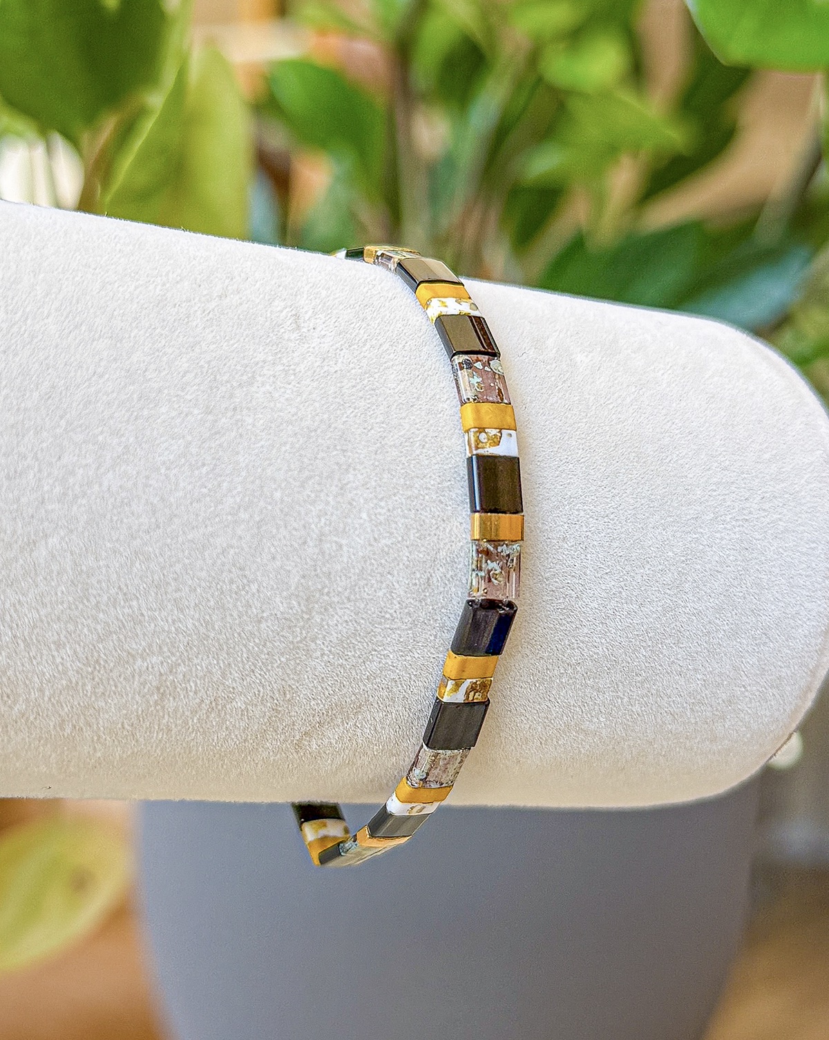 Prague bracelet close-up photograph in black, ochre, ivory, and bronze tones