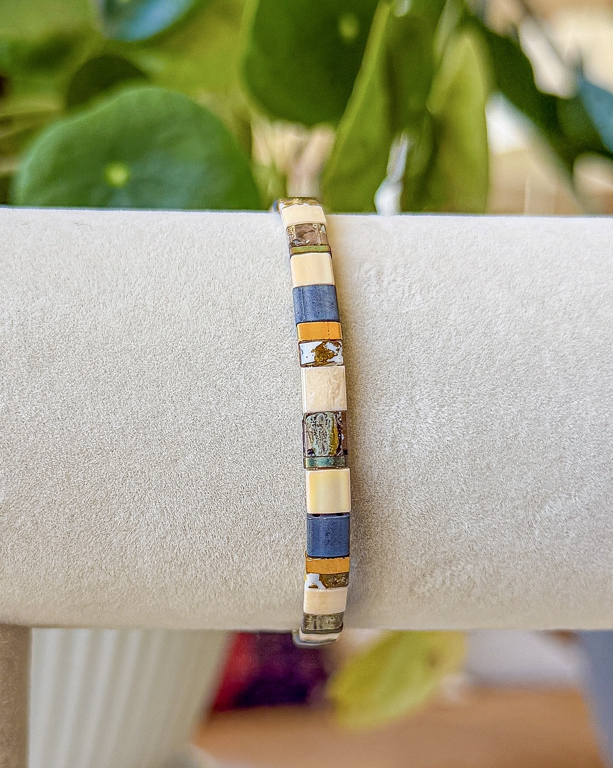 Stockholm bracelet close-up photograph in blue, slate, ivory, and bronze tones